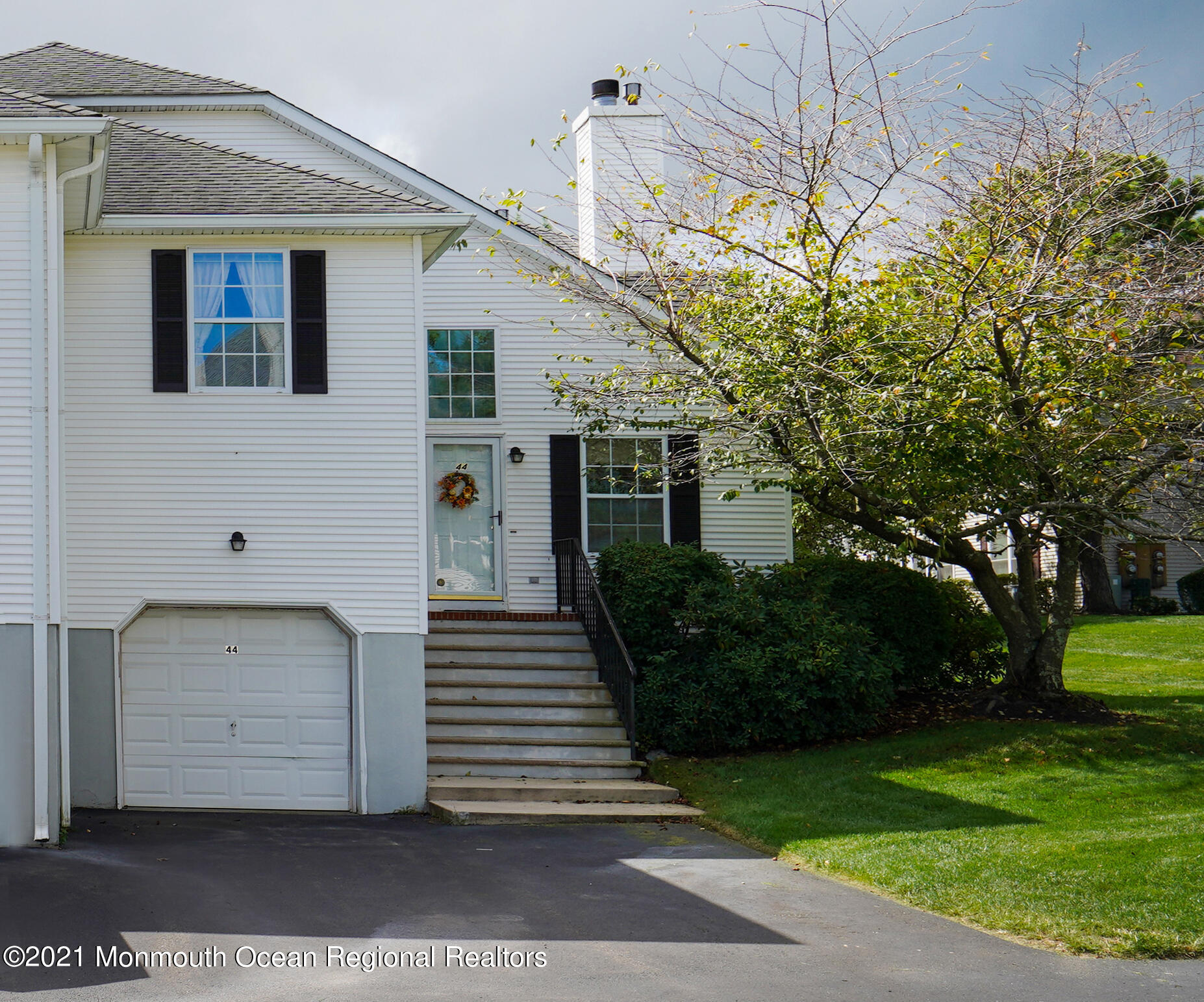 44 Racquet Road Wall, NJ 07719 - Photo 19 of 21 a view of a white house with a yard and plants