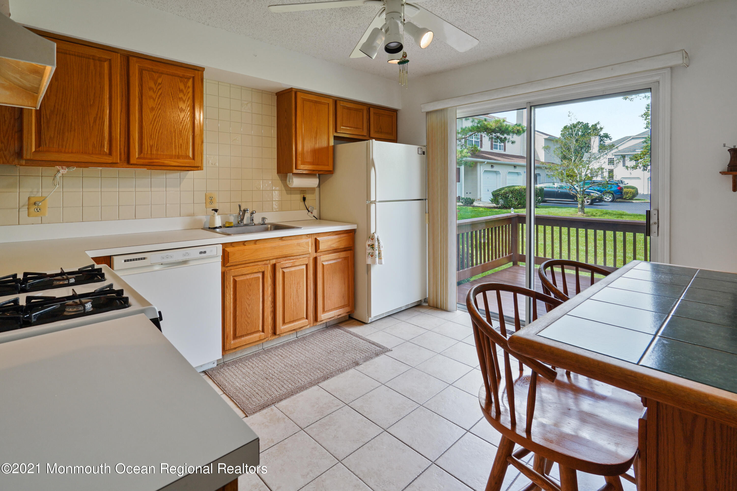 44 Racquet Road Wall, NJ 07719 - Photo 5 of 21 a kitchen with a table chairs stove and refrigerator