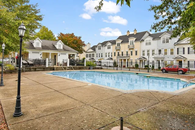 a view of a white house with a swimming pool