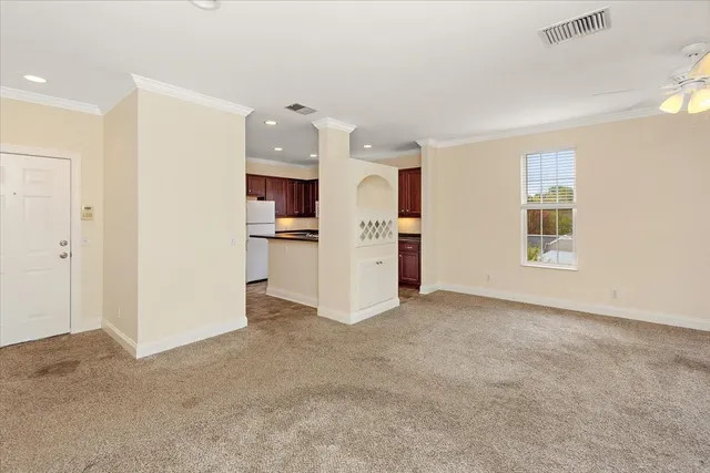 a view of a kitchen with refrigerator and a sink