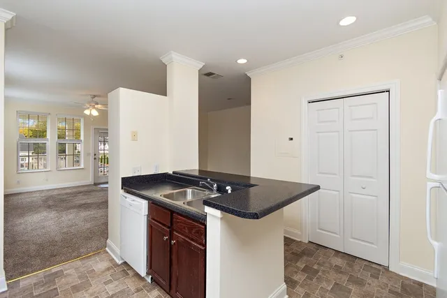 a kitchen that has a sink and a stove in it