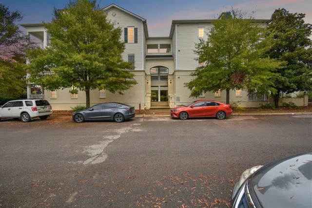 a buildings with car parked in front of it