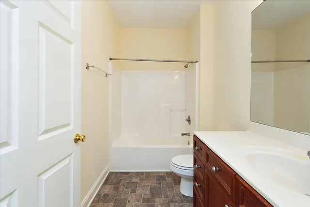 a bathroom with a sink a toilet a shower and a mirror