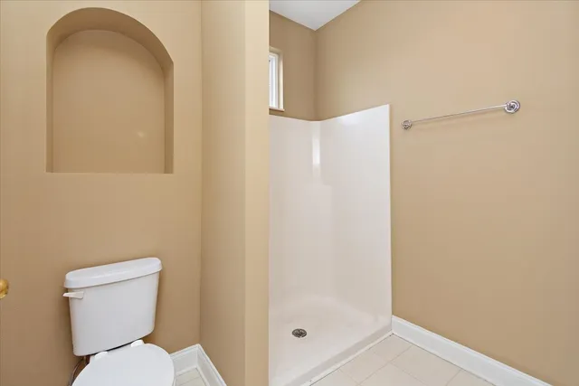 a white toilet sitting next to a bathroom sink