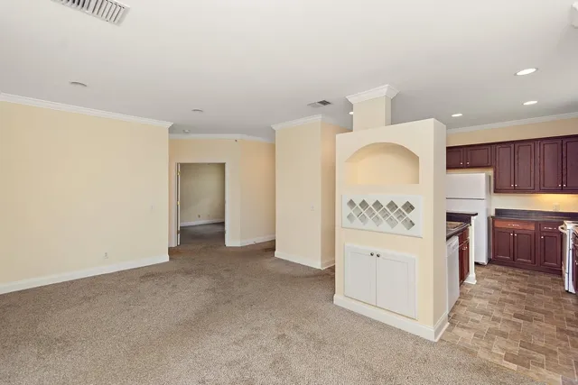a view of kitchen with refrigerator and cabinets