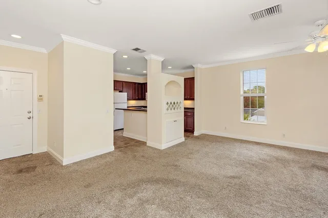 a view of a kitchen with refrigerator and a sink