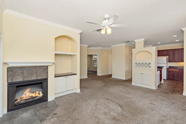 a view of a kitchen with a fireplace a kitchen a sink and a refrigerator