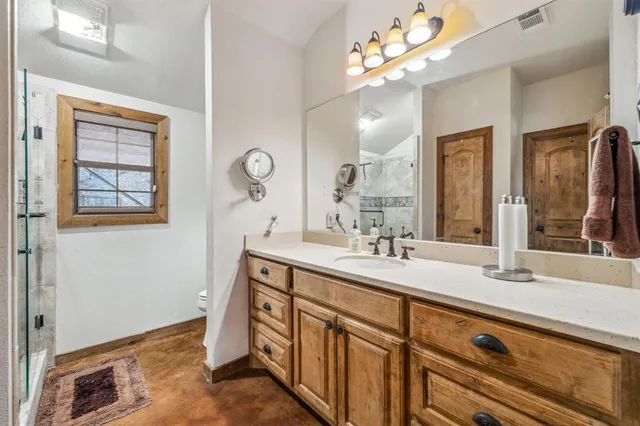 a spacious bathroom with a double vanity sink and a mirror