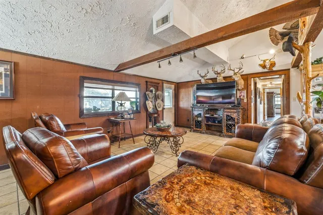 a living room with furniture a ceiling fan and a window