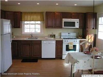 307 Herbertsville Road Brick, NJ 08724 - Photo 2 of 10 a kitchen with stainless steel appliances granite countertop a stove a sink dishwasher and a microwave oven with cabinets