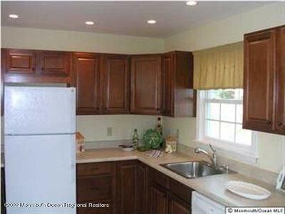 307 Herbertsville Road Brick, NJ 08724 - Photo 3 of 10 a kitchen with a sink a refrigerator and a stove