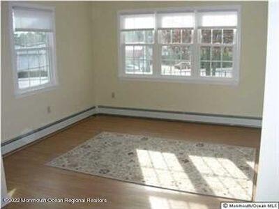 307 Herbertsville Road Brick, NJ 08724 - Photo 5 of 10 an empty room with wooden floor and windows