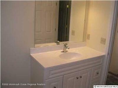 307 Herbertsville Road Brick, NJ 08724 - Photo 8 of 10 a bathroom with a sink and a mirror