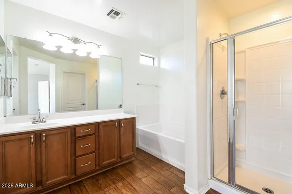 a spacious bathroom with a double vanity sink and a mirror