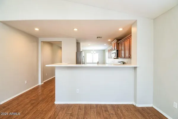 a view of kitchen and hall with wooden floor