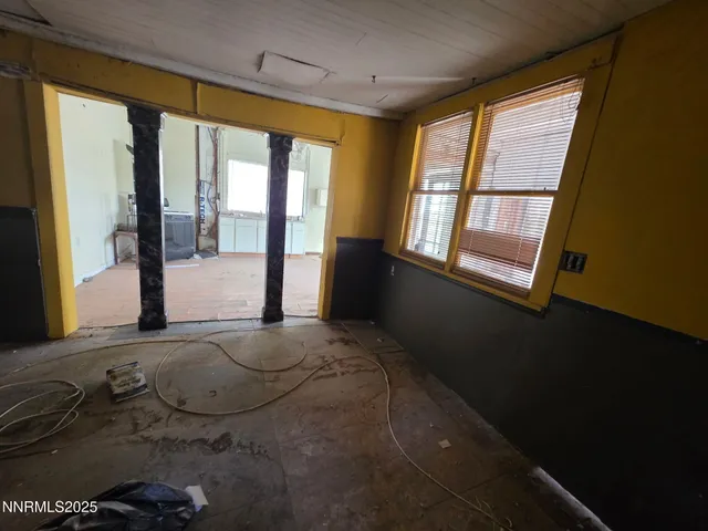 a room with a bed and wooden floor