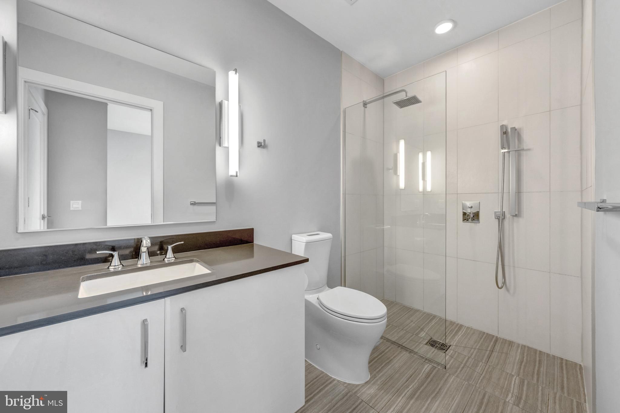 88 V Street Southwest, Unit 808 Washington, DC 20024 - Photo 29 of 47 a bathroom with a granite countertop sink toilet and shower