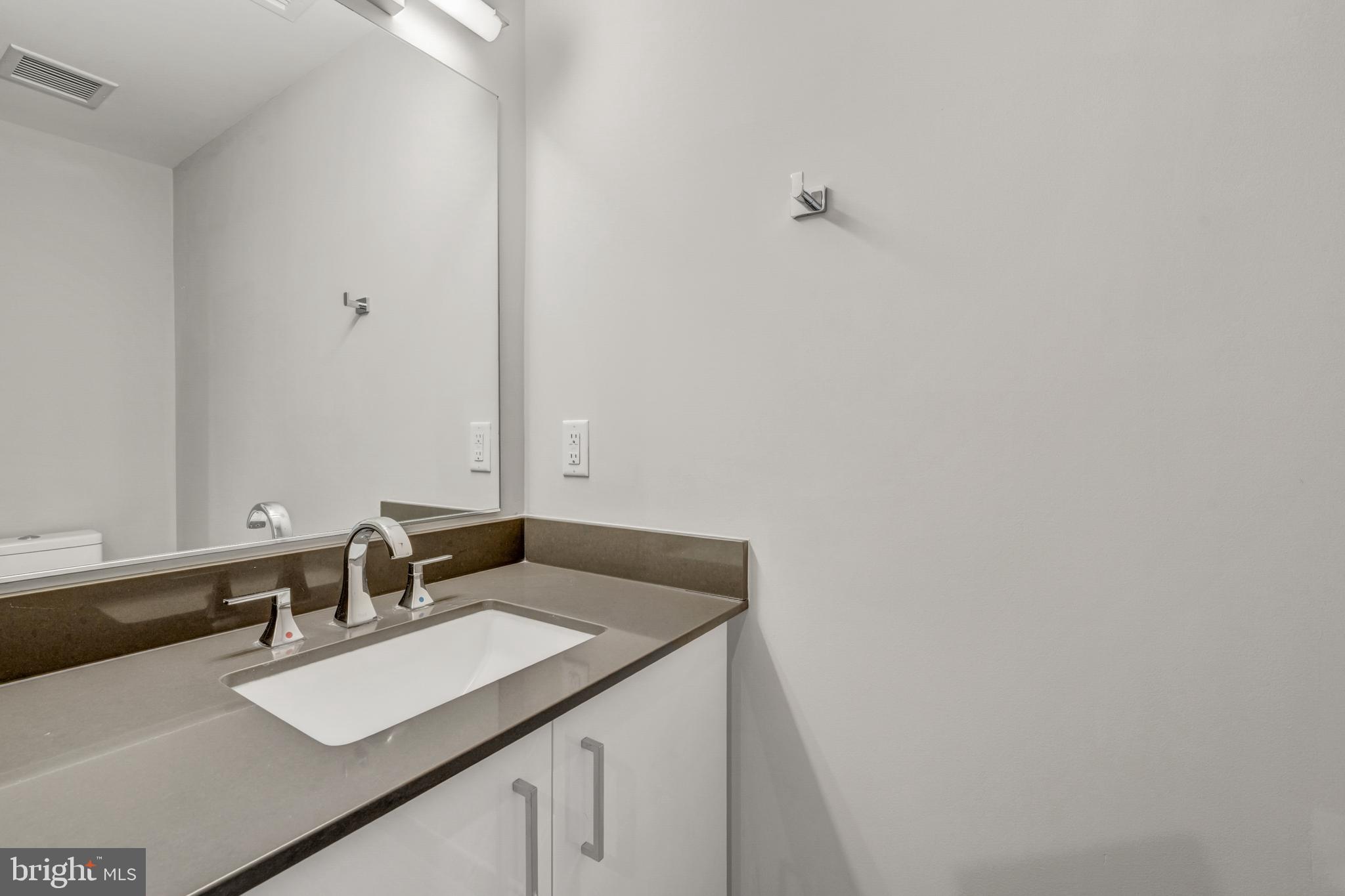 88 V Street Southwest, Unit 808 Washington, DC 20024 - Photo 31 of 47 a bathroom with a sink and a mirror