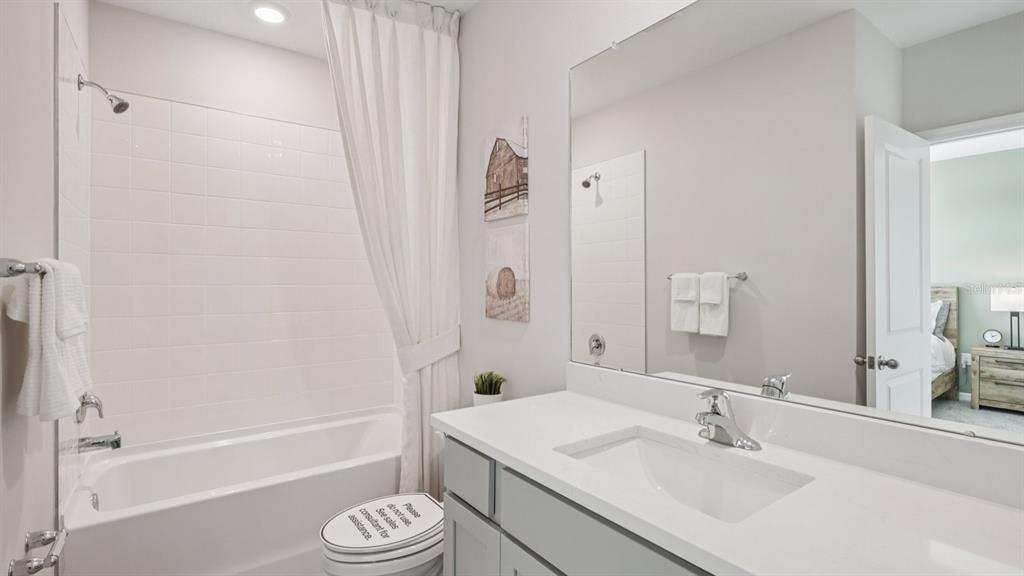 32516 Welling Blade Loop Wesley Chapel, FL 33545 - Photo 25 of 39 a bathroom with a sink a toilet and a bathtub