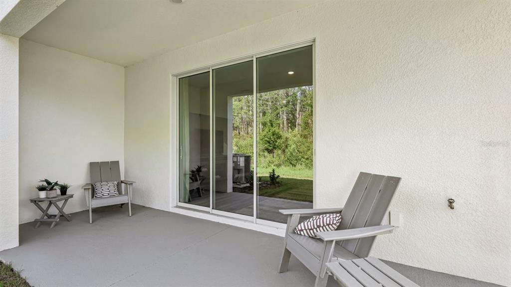 32516 Welling Blade Loop Wesley Chapel, FL 33545 - Photo 31 of 39 a living room with furniture and a large window