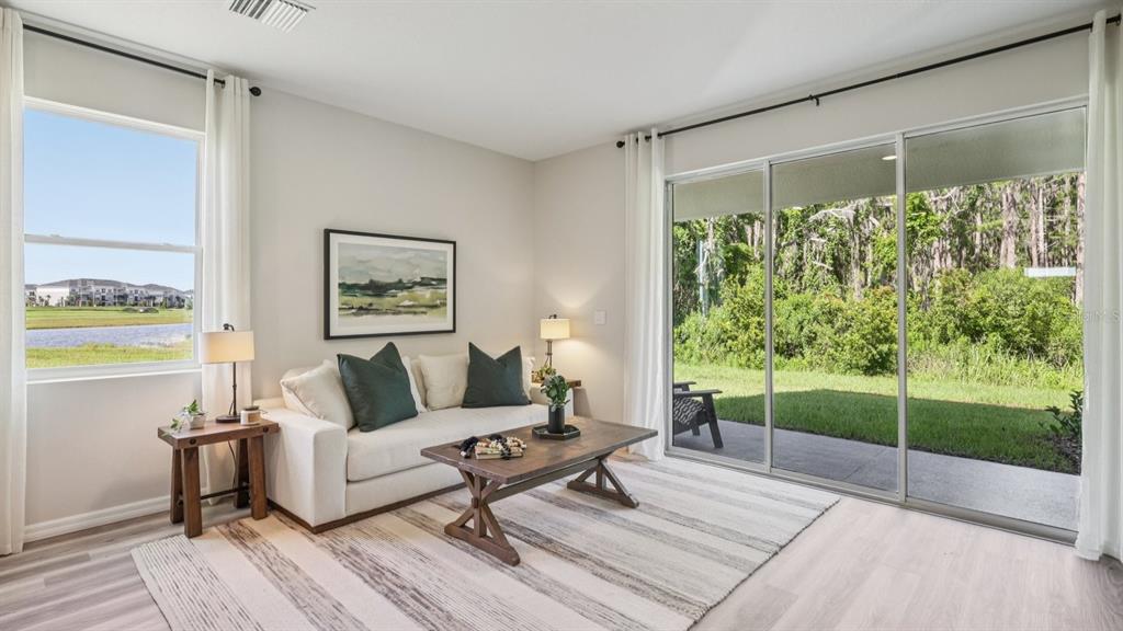 32516 Welling Blade Loop Wesley Chapel, FL 33545 - Photo 6 of 39 a living room with a couch and a table