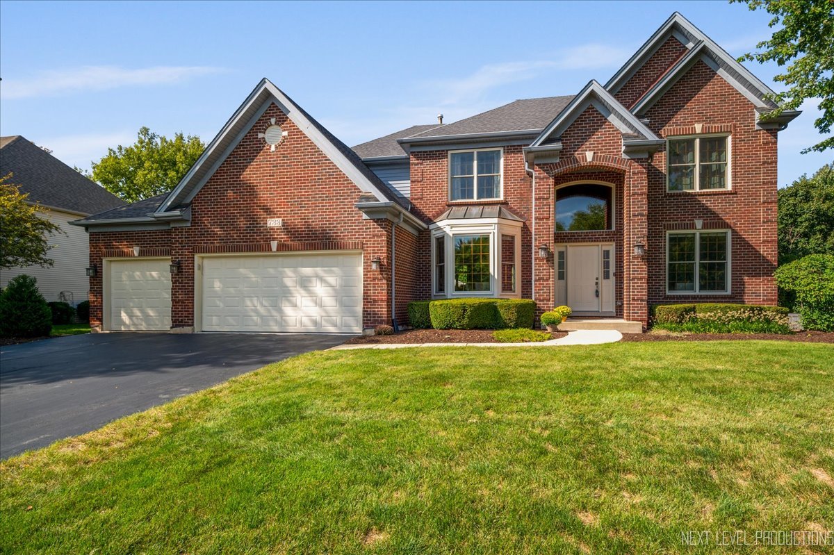 a front view of a house with a yard and garage