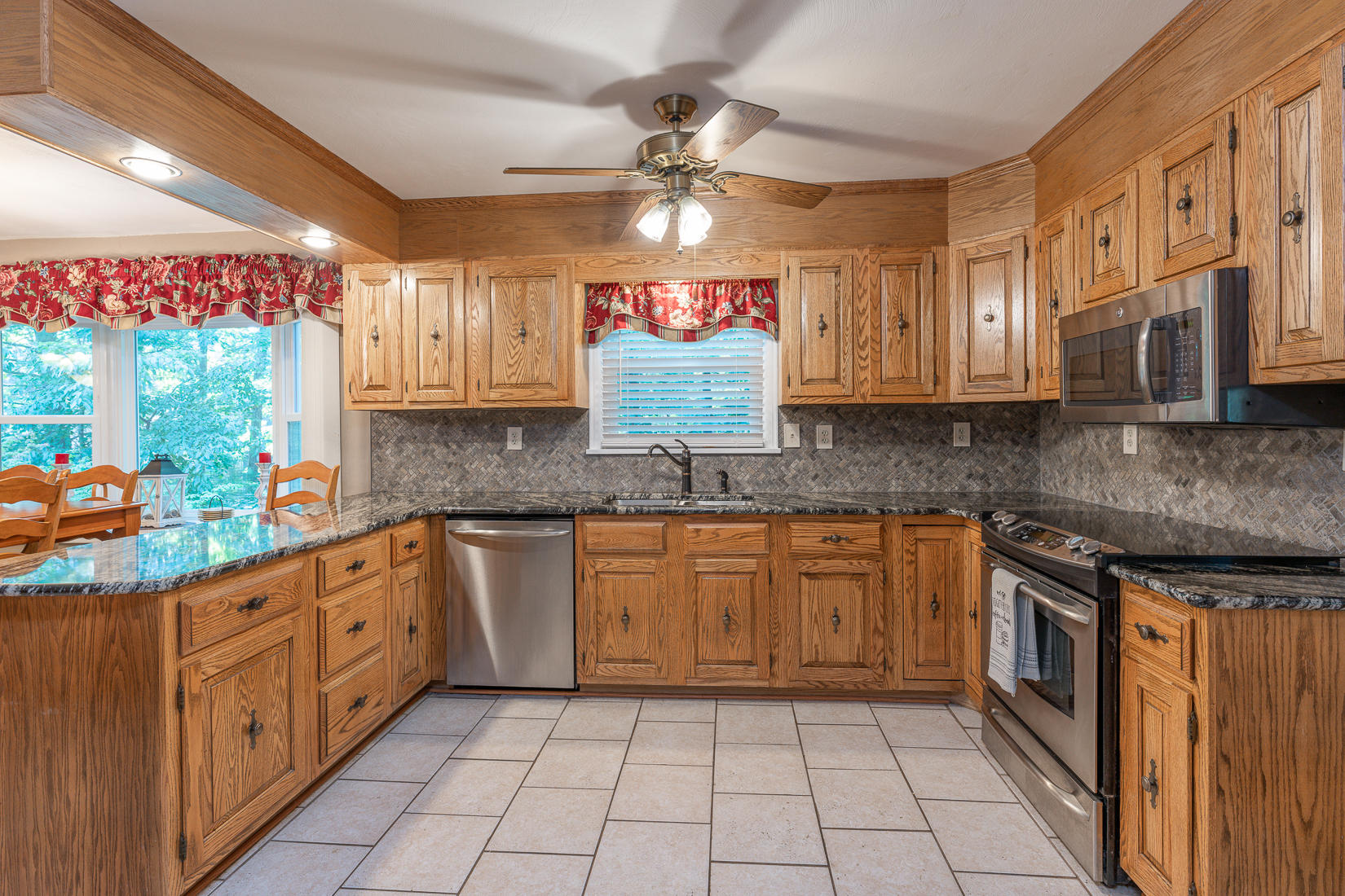 212 Queen Regent Court Blue Ridge, VA 24064 - Photo 22 of 55 a kitchen with stainless steel appliances granite countertop a sink and cabinets