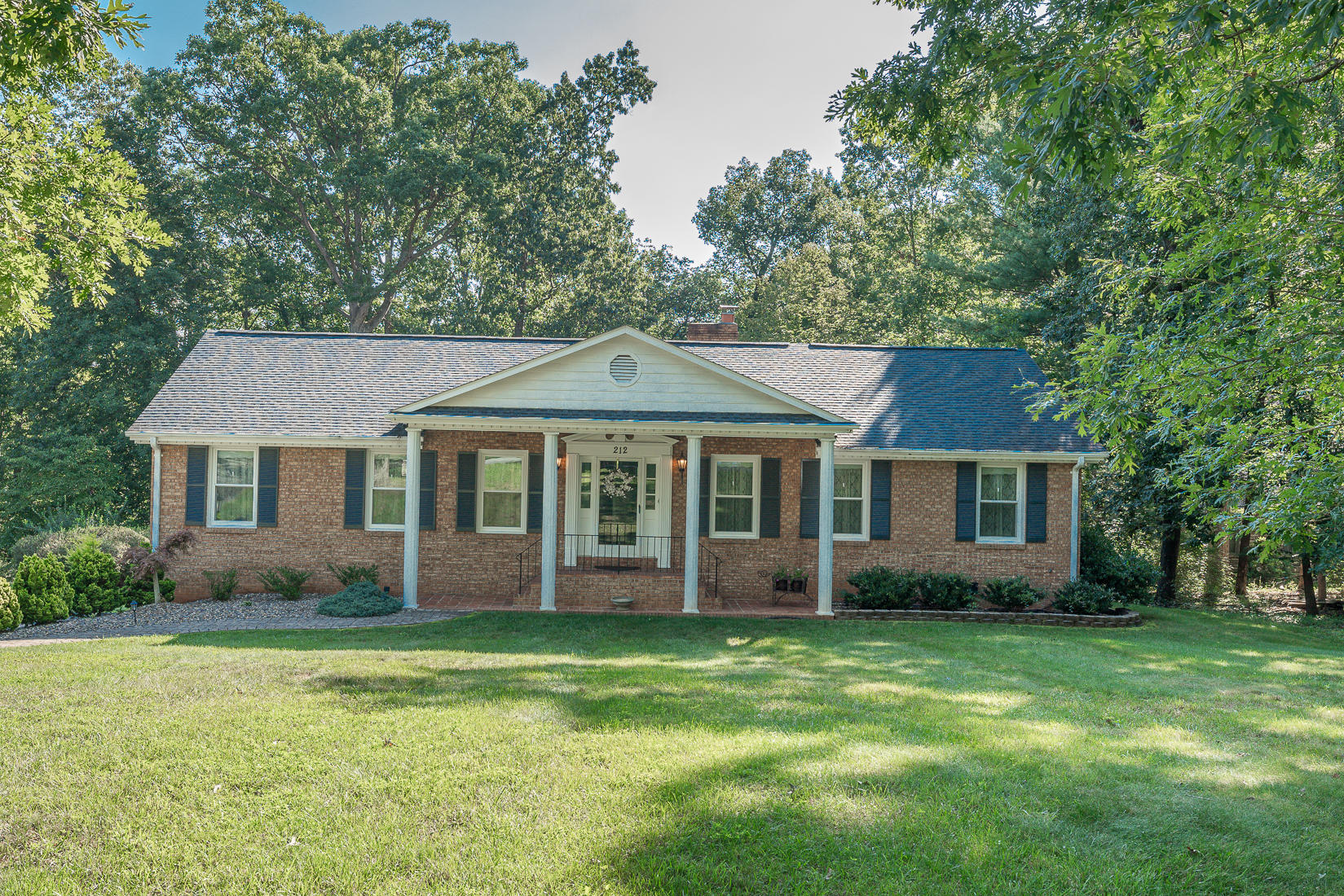 212 Queen Regent Court Blue Ridge, VA 24064 - Photo 4 of 55 a front view of a house with a garden