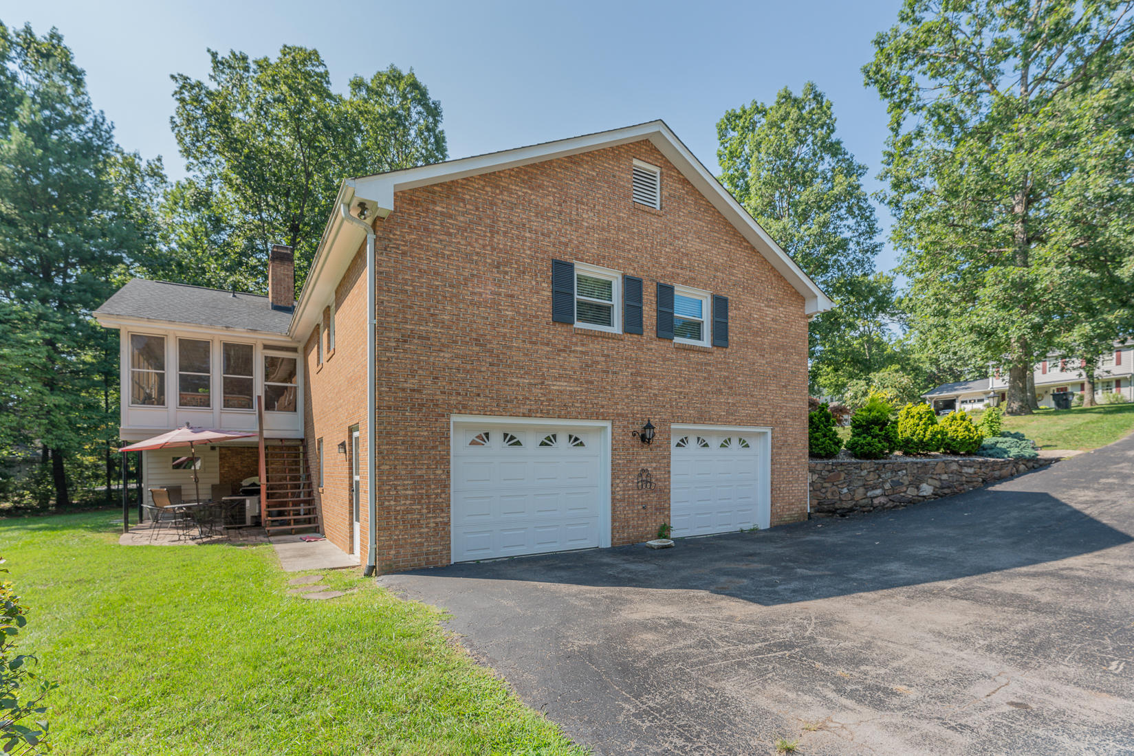 212 Queen Regent Court Blue Ridge, VA 24064 - Photo 5 of 55 a front view of a house with a yard and trees