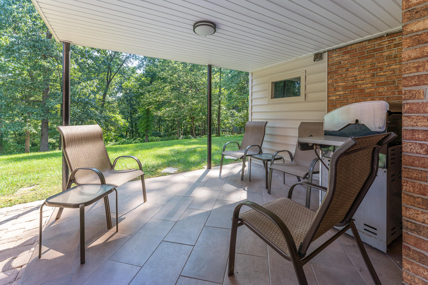 212 Queen Regent Court Blue Ridge, VA 24064 - Photo 8 of 55 a view of a patio with table and chairs next to a yard