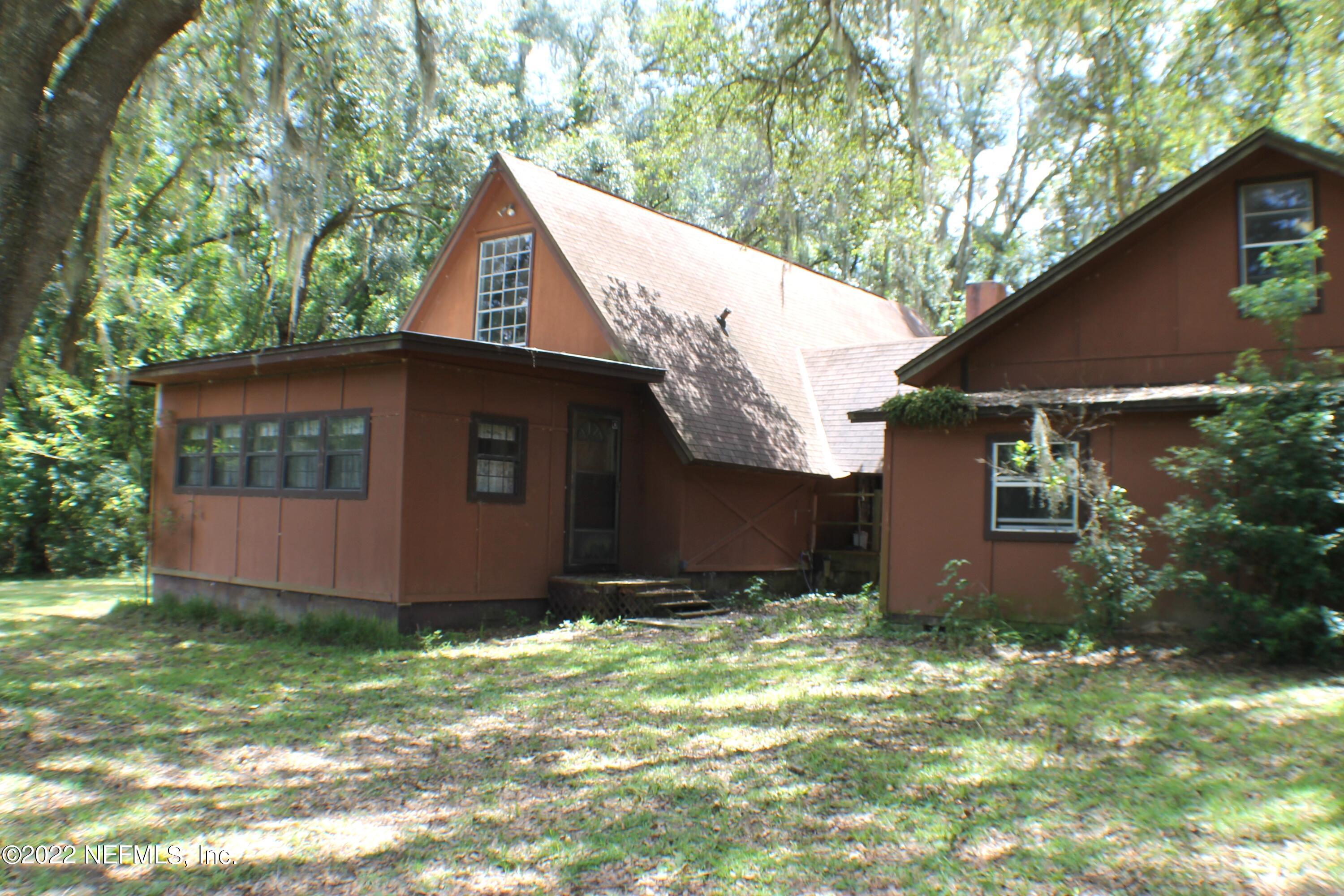 6060 Taylor Road Jacksonville, FL 32234 - Photo 3 of 27 a backyard of a house with lots of green space
