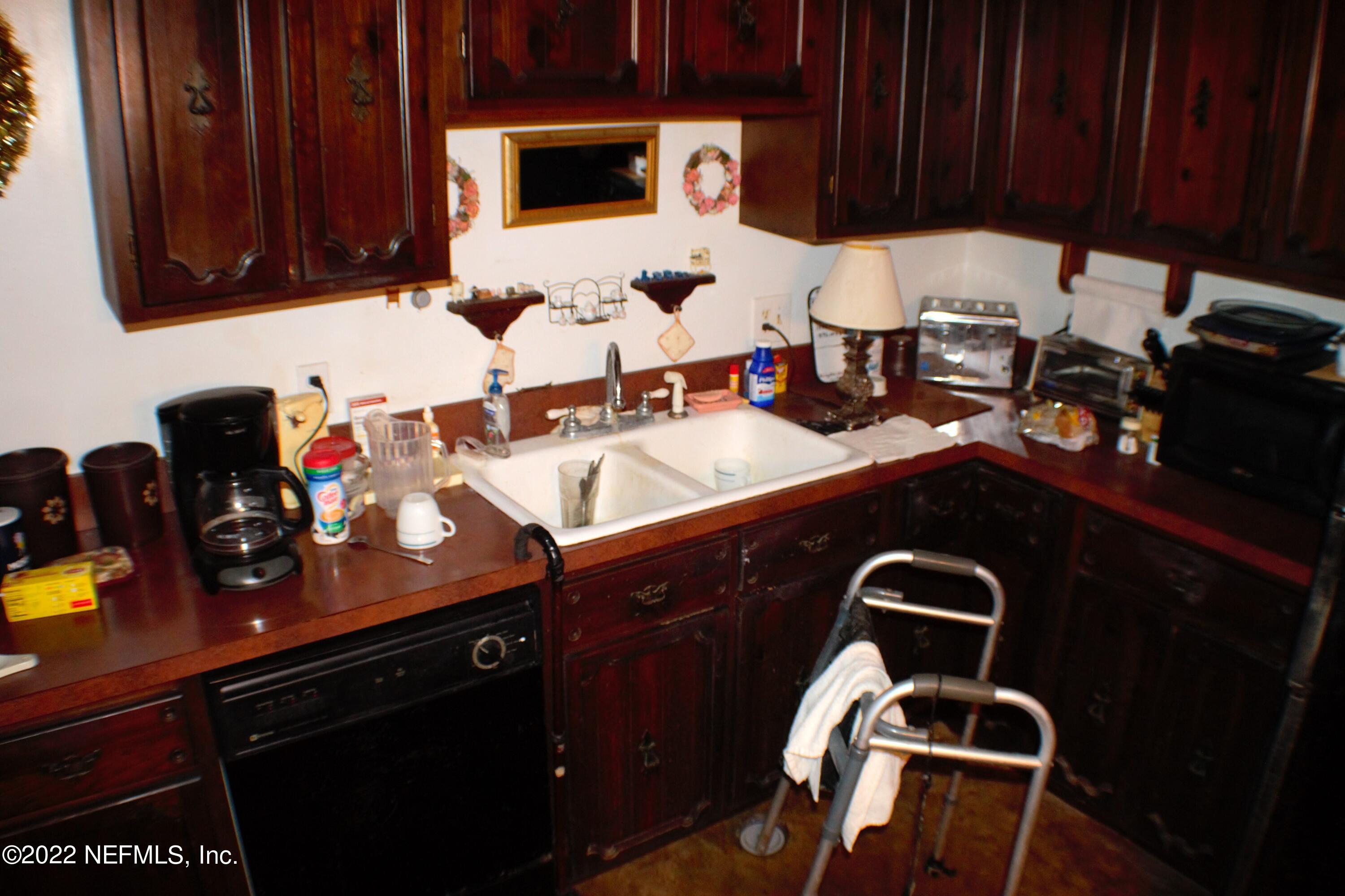 6060 Taylor Road Jacksonville, FL 32234 - Photo 7 of 27 a kitchen with a sink and cabinets