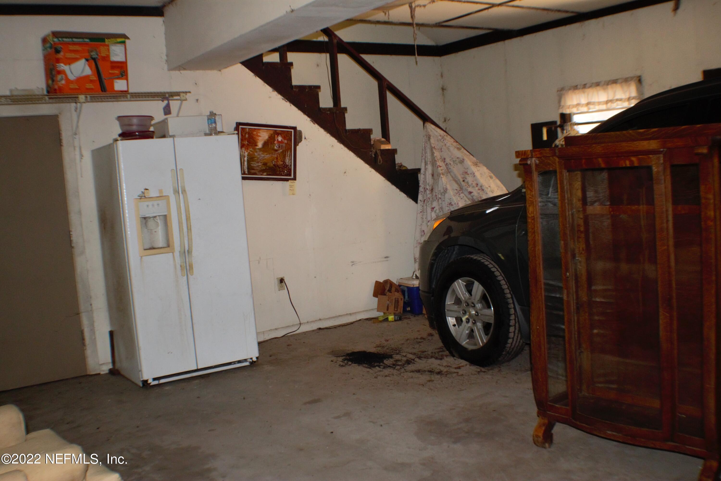 6060 Taylor Road Jacksonville, FL 32234 - Photo 8 of 27 a view of a garage with stairs