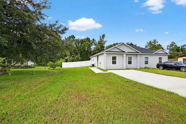 a front view of house with yard and green space