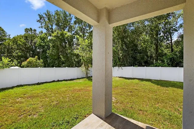 a view of yard with swimming pool and outdoor seating