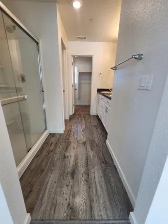 a view of a hallway view of wooden floor