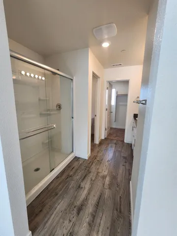 a bathroom with a shower and a sink