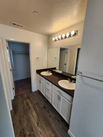 a bathroom with a double vanity sink and mirror