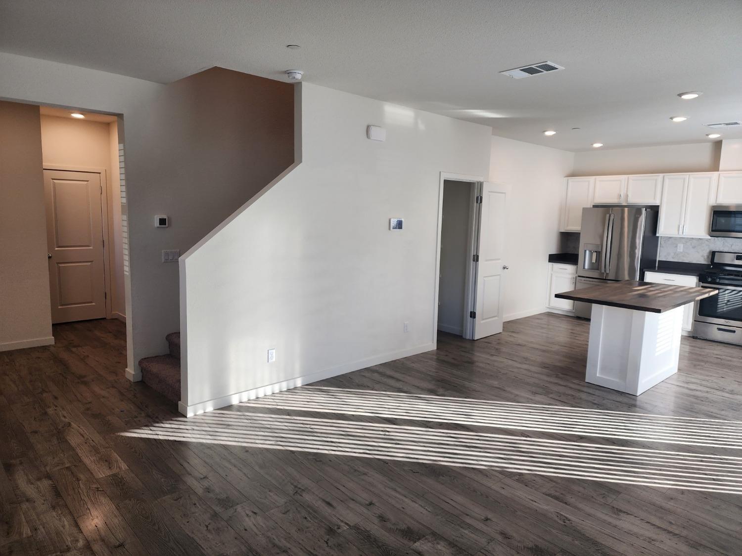 4384 Silver Cedar Lane Sacramento, CA 95834 - Photo 3 of 21 a view of a kitchen cabinets and wooden floor