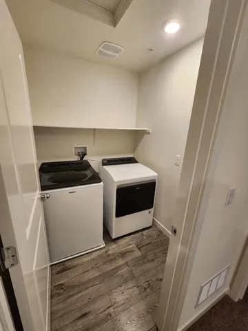 a utility room with sink dryer and washer