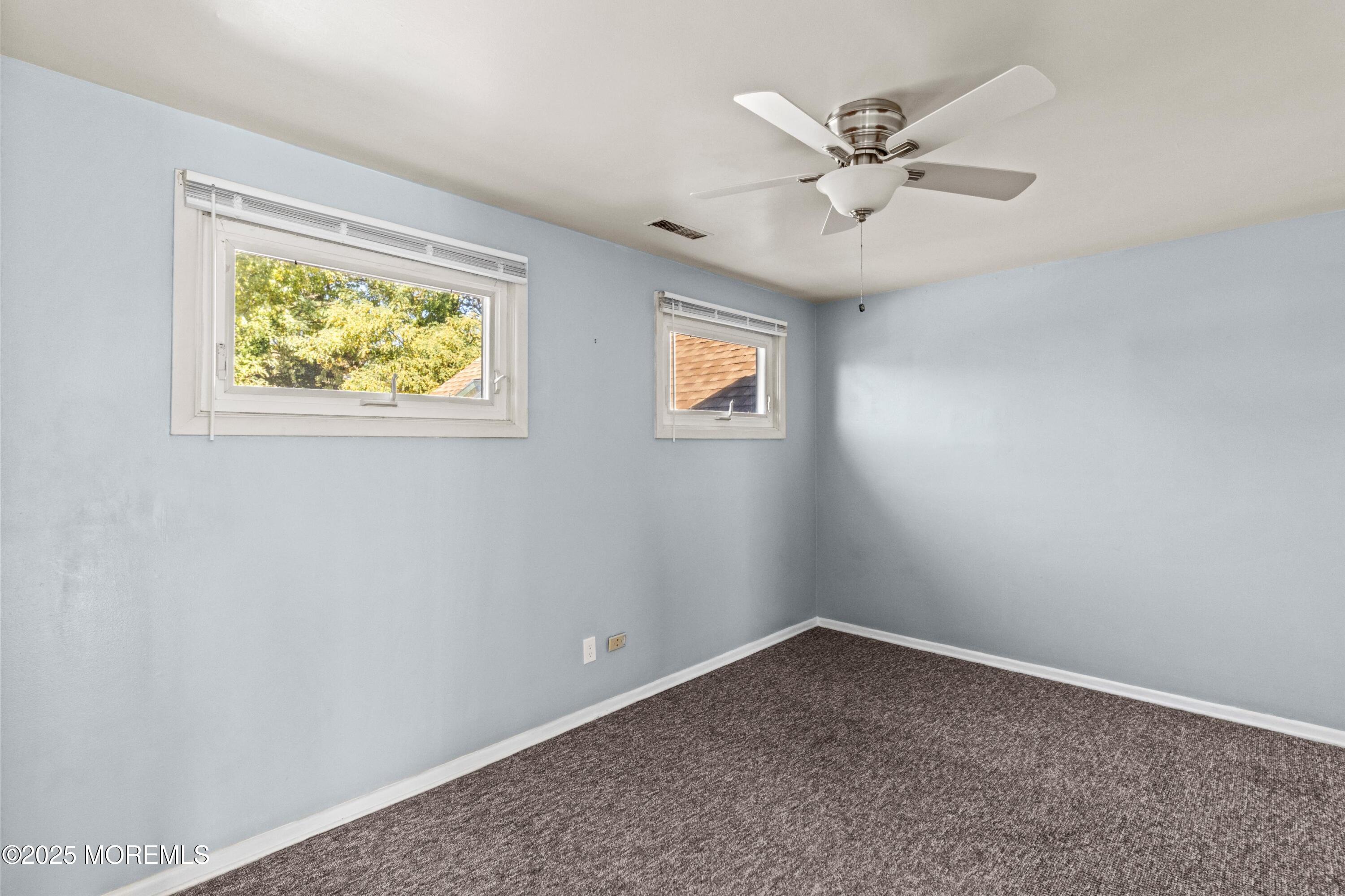 633 North Manetta Drive Point Pleasant, NJ 08742 - Photo 13 of 28 an empty room with a window and a ceiling fan