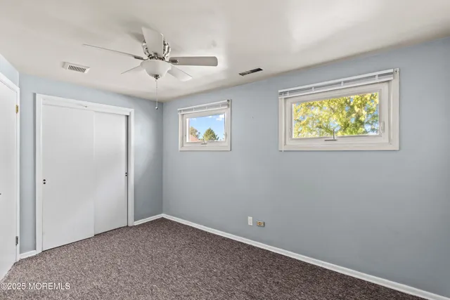 a view of room with window and ceiling fan
