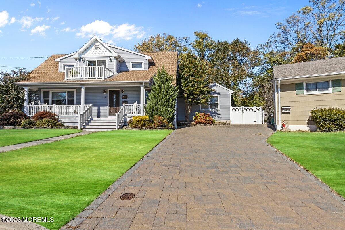 633 North Manetta Drive Point Pleasant, NJ 08742 - Photo 2 of 28 a front view of a house with a yard table and chairs