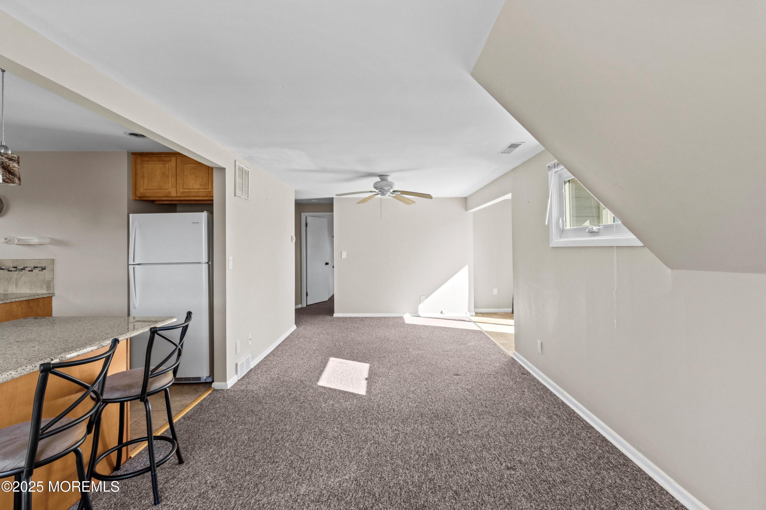 633 North Manetta Drive Point Pleasant, NJ 08742 - Photo 9 of 28 a view of a livingroom with furniture and a ceiling fan