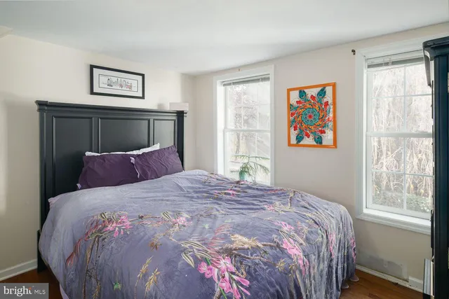 a bedroom with a bed and painting on the wall