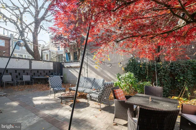 a view of a patio with table and chairs and potted plants