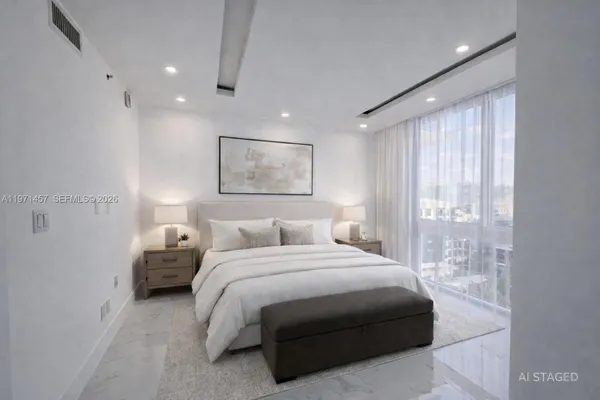 a spacious bedroom with a bed and a large mirror