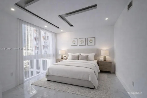 a bedroom with a large bed and a large window