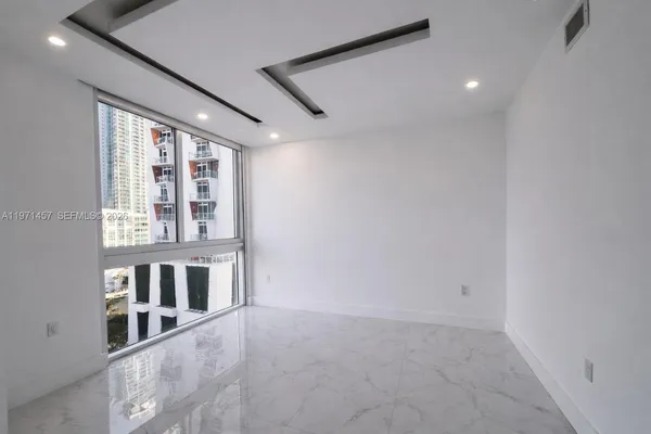 a view of an empty room with a window