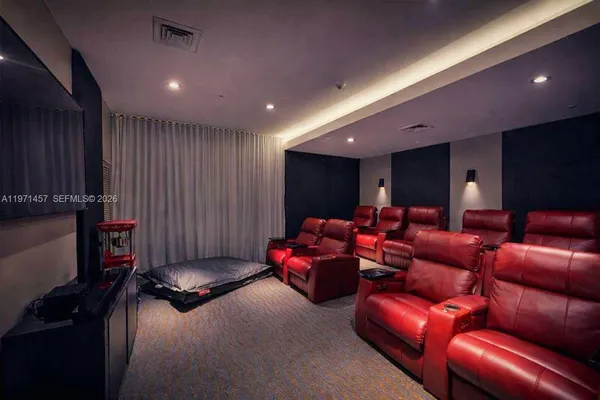 a media room with lots of chairs and a projector screen